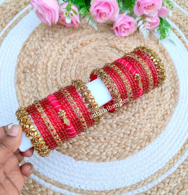 Golden with red stone set